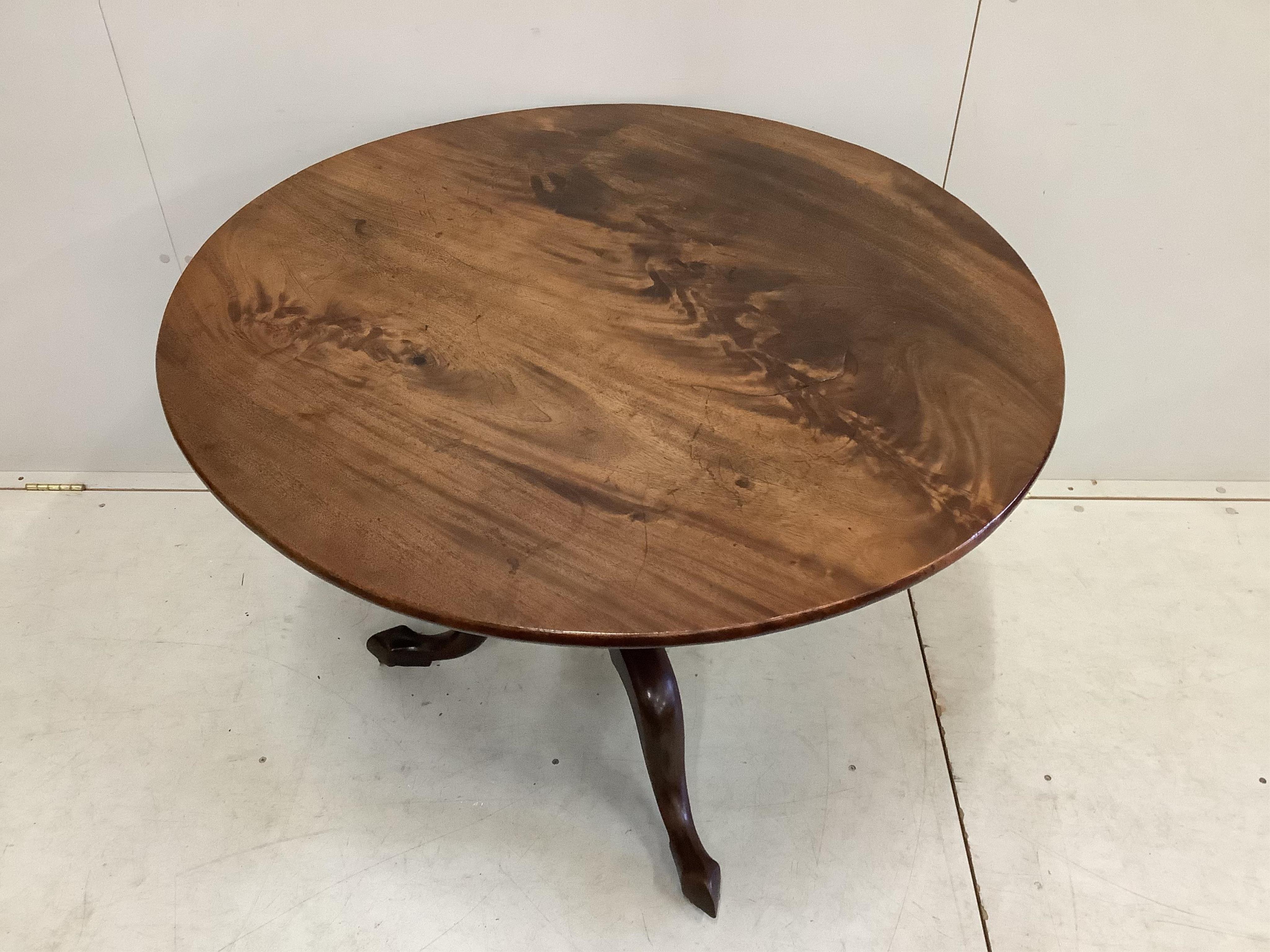 A George III circular mahogany tilt top tripod tea table, diameter 99cm, height 75cm together with four George III mahogany dining chairs. Condition - fair